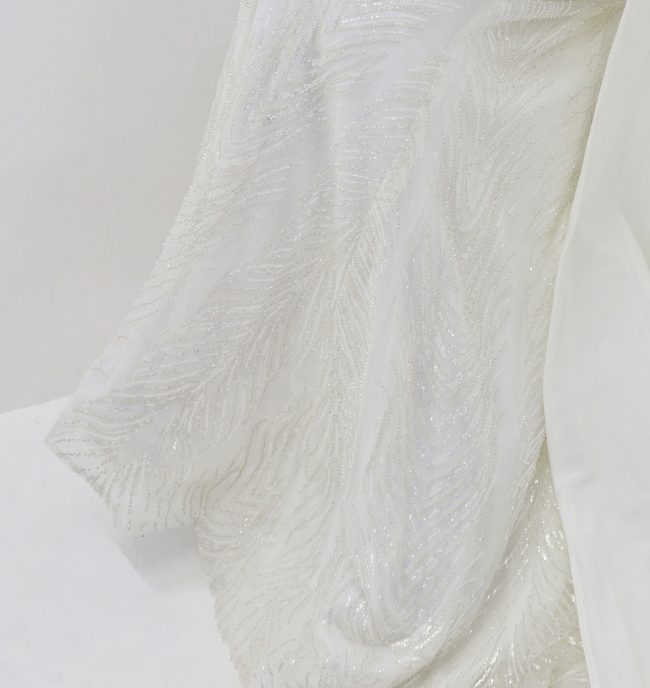 Beautiful Deep V-neckline White gown with a flowing train - Image 3